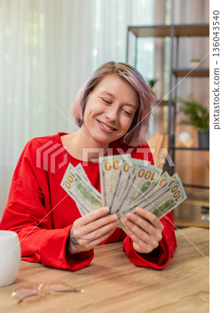 Woman happily counting dollars cash money, smiling, satisfied financial success and wealthy emotions Woman happily counting dollars cash money, smiling, satisfied financial success and wealthy emotions 136043540