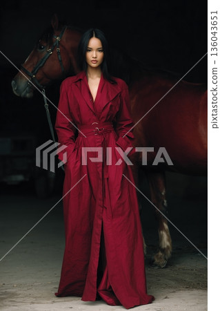 portrait of red dressed asian woman with horse 136043651