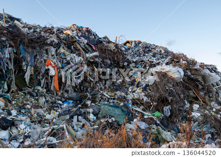 Heaps of refuse stretch endlessly towards the sky, showcasing alarming pollution and the urgent need for ecological awareness and action Heaps of refuse stretch endlessly towards the sky, showcasing alarming pollution and the urgent need for ecological awareness and action 136044520