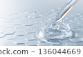 A drop of hyaluronic acid or liquid water falls on a blue surface. The concept of skin care and elasticity restoration. Clear gel serum texture. Cosmetic gel skincare cream product close up 136044669