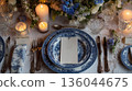Wedding blue white rustic table set up in classic style with blue flowers and candles and plates 136044675