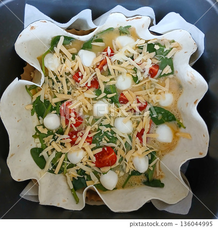 Tortilla bowl stuffed with greens, cherry tomato, mozzarella and herbs, a colorful fresh meal idea Tortilla bowl stuffed with greens, cherry tomato, mozzarella and herbs, a colorful fresh meal idea 136044995