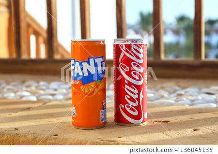 Egypt, Sharm El Sheikh - September 27, 2025 Two cans of popular carbonated drinks Coca-Cola and Fanta on a beautiful summer background. Editorial Egypt, Sharm El Sheikh - September 27, 2025 Two cans of popular carbonated drinks Coca-Cola and Fanta on a beautiful summer background. Editorial 136045135