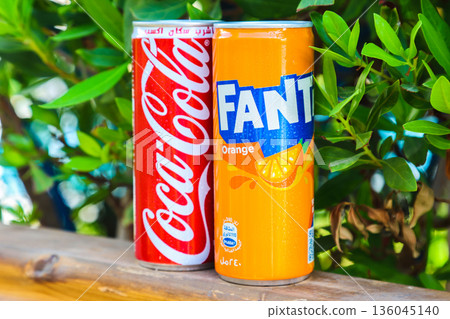 Egypt, Sharm El Sheikh - September 27, 2025 Two cans of popular carbonated drinks Coca-Cola and Fanta on a beautiful summer background. Editorial Egypt, Sharm El Sheikh - September 27, 2025 Two cans of popular carbonated drinks Coca-Cola and Fanta on a beautiful summer background. Editorial 136045140