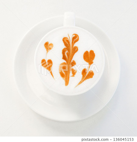 Latte with orange leaf latte art in a white cup on a saucer Latte with orange leaf latte art in a white cup on a saucer 136045153