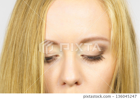 Girl showing eyes makeup Girl showing eyes makeup 136045247