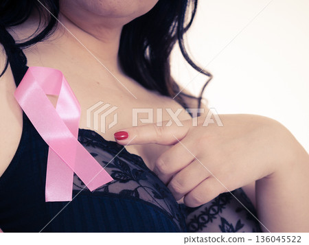 Woman chest in bra, pink cancer ribbon Woman chest in bra, pink cancer ribbon 136045522