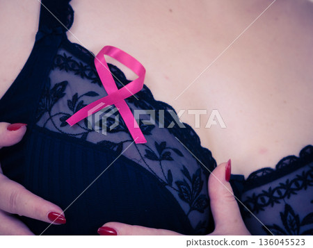Woman chest in bra, pink cancer ribbon Woman chest in bra, pink cancer ribbon 136045523