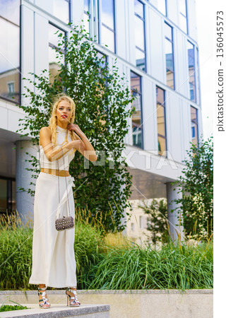Woman wearing crop top and culottes Woman wearing crop top and culottes 136045573
