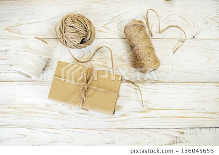Cardboard boxes and packing twine, delivery concept. Stacking of postal cardboard boxes and packing twine. Cardboard boxes and packing twine, delivery concept. Stacking of postal cardboard boxes and packing twine. 136045656