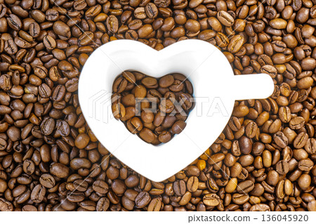 Heart shaped cup on coffee background 136045920