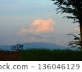 Dusk sky, cumulonimbus clouds, and a bicycle parked on the bank 136046129