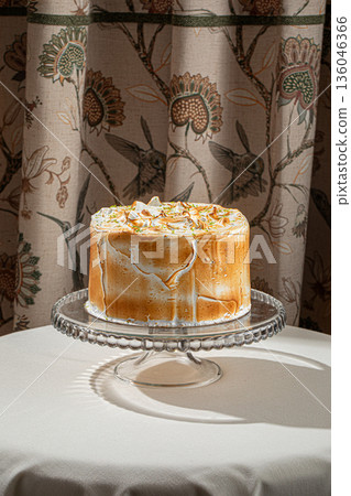 Meringue cake with toasted peaks and zest 136046366