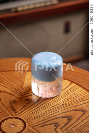 Cocktail with whipped blue foam in ribbed glass Cocktail with whipped blue foam in ribbed glass 136046389