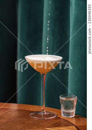 Sour style cocktail with foam and side shot Sour style cocktail with foam and side shot 136046393