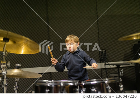 Young boy learning drums in music studio Young boy learning drums in music studio 136047226