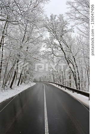 Snowy winter road. Dangerous car driving in the mountains in the winter. Concept for transportation, cars and travel. Snowy winter road. Dangerous car driving in the mountains in the winter. Concept for transportation, cars and travel. 136047406