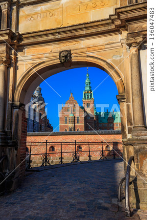 View of Frederiksborg castle through stone arch in Hillerod, Denmark 136047483