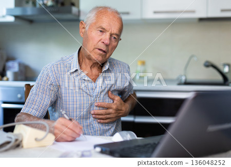 Old man having online medical consultation through internet Old man having online medical consultation through internet 136048252
