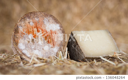 whole head of ripe country cheese and slices on hay whole head of ripe country cheese and slices on hay 136048264