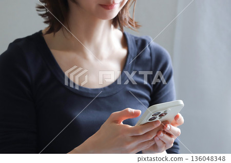 Hands for operating a smartphone Hands for operating a smartphone 136048348