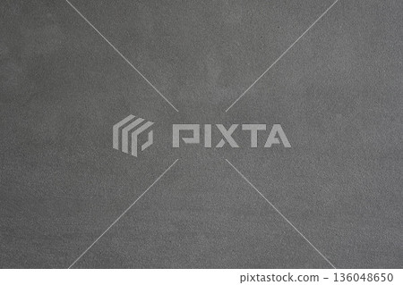 A gray cement wall background with a porous and granular texture. A fresh, drying layer of plaster with an abstract overlay pattern. A monochromatic backdrop for graphic design with ample copy space. A gray cement wall background with a porous and granular texture. A fresh, drying layer of plaster with an abstract overlay pattern. A monochromatic backdrop for graphic design with ample copy space. 136048650