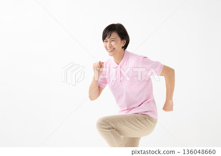 A woman in a running pose A woman in a running pose 136048660