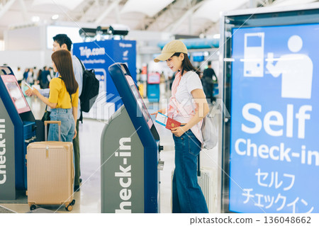 Travelers checking in by themselves at the airport (Photo courtesy of Kansai International Airport (KIX)) 136048662