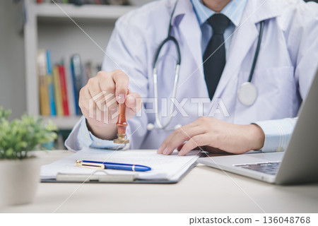 Doctor in white coat with stethoscope stamping medical document for approval. Concept for health certificate, insurance claim, diagnosis validation, and healthcare paperwork in a hospital or clinic Doctor in white coat with stethoscope stamping medical document for approval. Concept for health certificate, insurance claim, diagnosis validation, and healthcare paperwork in a hospital or clinic 136048768