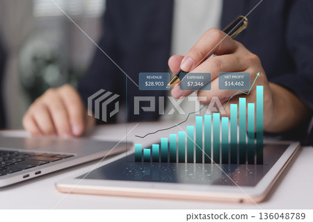 Business analyst reviews revenue expenses profit on tablet in office for financial report forecast strategy growth trend KPI data analytics dashboard investment performance ROI budgeting Business analyst reviews revenue expenses profit on tablet in office for financial report forecast strategy growth trend KPI data analytics dashboard investment performance ROI budgeting 136048789