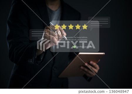 Rating, review a business professional uses a stylus on a tablet to post five stars customer feedback and a verified testimonial, boosting e commerce trust and satisfaction. 136048947
