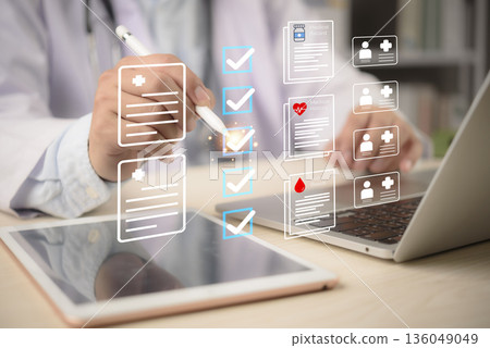 EHR, checklist Doctor taps tablet beside laptop to review medical records and patient data privacy, ticking tasks across history, lab results, and profiles. concept secure digital workflow. 136049049