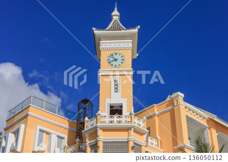 Iceland Phu Quoc Vietnam 5.7.2025. A tall yellow building with a clock tower and a balcony Iceland Phu Quoc Vietnam 5.7.2025. A tall yellow building with a clock tower and a balcony 136050112