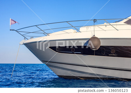 A large boat with a white flag on the front 136050123