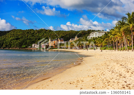 A beach with a house in the background A beach with a house in the background 136050141