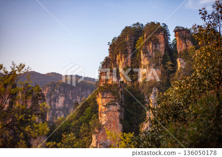 A mountain range with a beautiful view of the sky A mountain range with a beautiful view of the sky 136050178