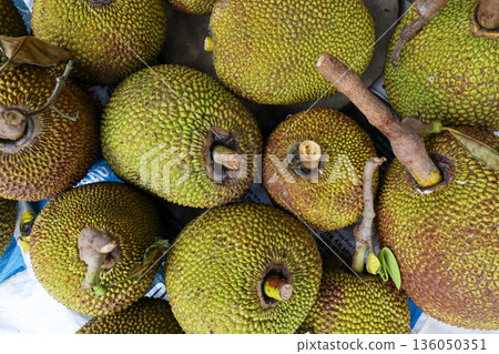 A bunch of green fruit with brown spots A bunch of green fruit with brown spots 136050351