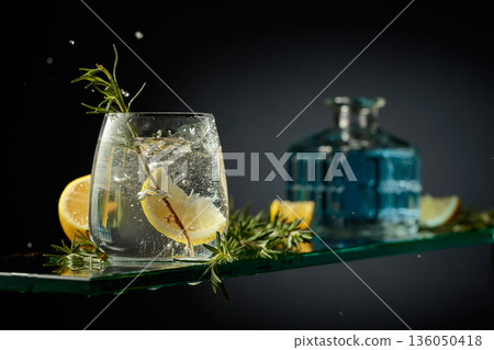 Gin tonic cocktail with lemon and rosemary. Gin tonic cocktail with lemon and rosemary. 136050418