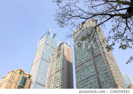 Chongqing China 4.7.2025. A city skyline with tall buildings and a clear blue sky Chongqing China 4.7.2025. A city skyline with tall buildings and a clear blue sky 136050481