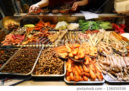 A variety of seafood and vegetables are displayed on a table 136050506