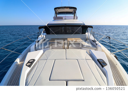A boat with a white top and a blue ocean in the background A boat with a white top and a blue ocean in the background 136050521