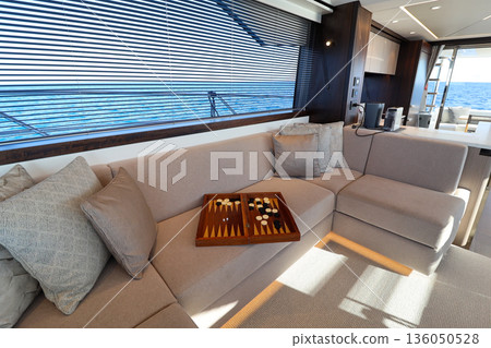 Luxury boat interior with sofa, galley, and sea view 136050528