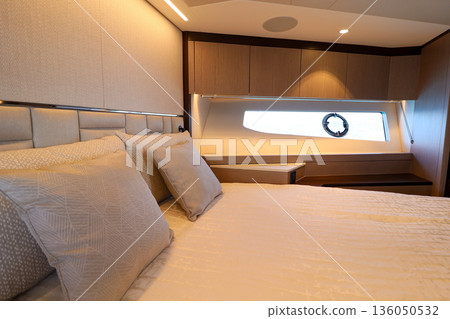 A bedroom with a white bed and two pillows in luxury boat A bedroom with a white bed and two pillows in luxury boat 136050532