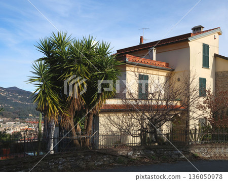 Traditional buildings, mountain houses. Nature and architecture of Liguria. Blue sky, clouds, and backdrop for design. Traditional buildings, mountain houses. Nature and architecture of Liguria. Blue sky, clouds, and backdrop for design. 136050978