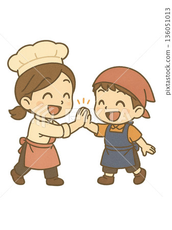 一個男孩戴著三角繃帶，穿著圍裙，笑容滿面地和一位女糕點師擊掌。 136051013