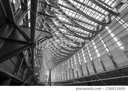 A modern architectural interior space with a series of curved structures 136051609