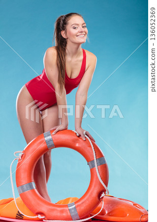 Lifeguard woman on duty with ring buoy lifebuoy. 136052369