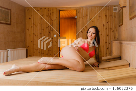 Woman relaxing in spa sauna. Woman relaxing in spa sauna. 136052376