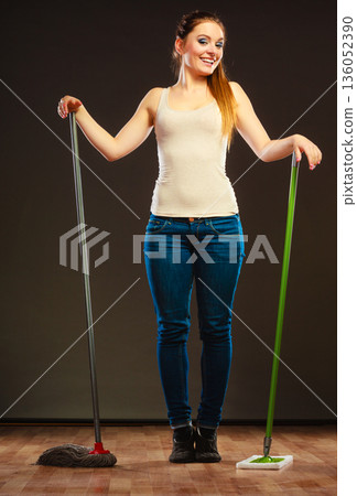 Funny cleaning woman mopping floor 136052390