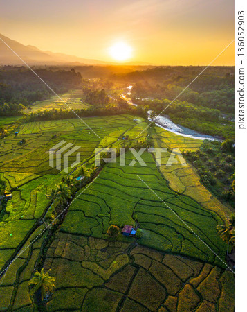 Beautiful morning view in Indonesia, panoramic landscape of rice fields with mountain ranges and clear sky Beautiful morning view in Indonesia, panoramic landscape of rice fields with mountain ranges and clear sky 136052903